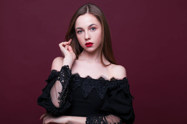Portrait of a young beautiful girl in black dress  - Photo, image