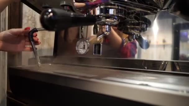 Barista produces steam from the coffee machine - Кадри, відео