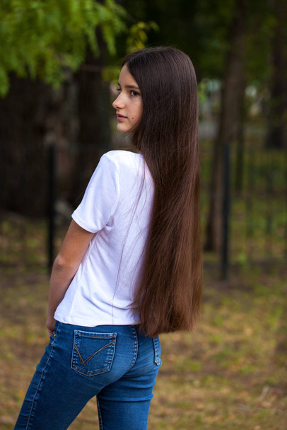 Female brunette hair, rear view, summer park - 写真・画像