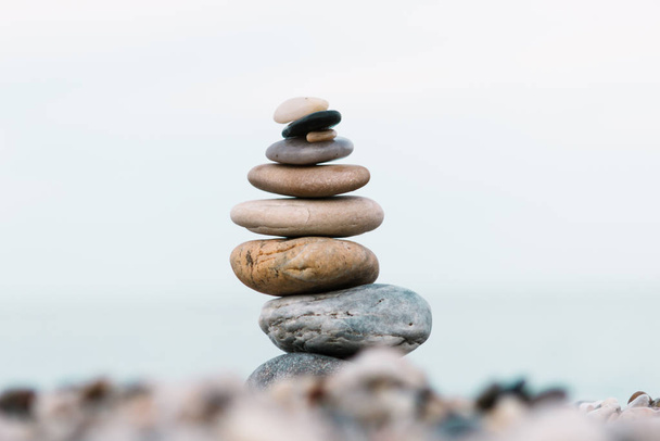 Spa and wellness background. Stack of pebble stones on the beach. - Photo, Image