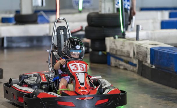 A Child Driving a Go-Kart Circuit - Фото, изображение