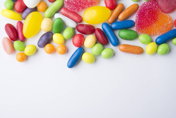 Border of colorful jelly candies on white - Valokuva, kuva