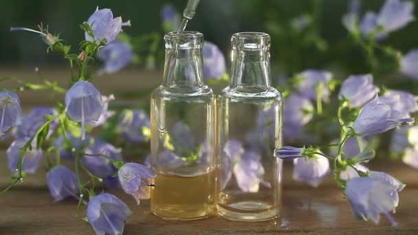 Essence of flowers on table in beautiful glass jar - Footage, Video