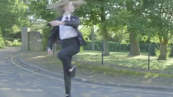 Senior school girl practising ballet on the way to school themes of ballet carefree routines education  - Metraje, vídeo
