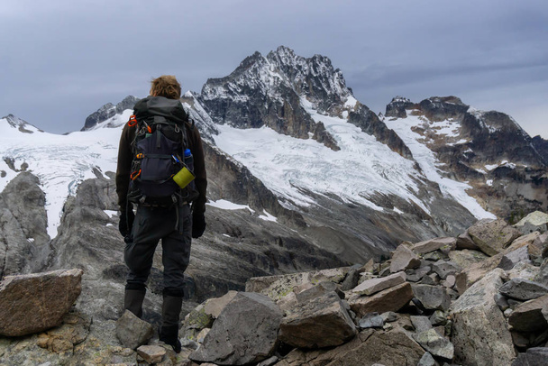 Maceracı adam Kanada 'nın güzel dağ manzarasında yürüyüş yapıyor. - Fotoğraf, Görsel