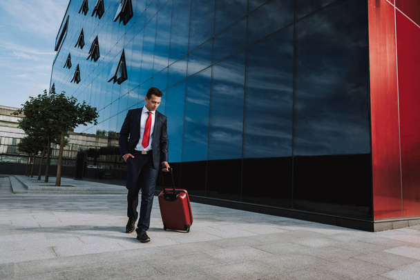 Employee walking with suitcase in city stock photo - Photo, image