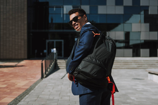 Joyful exacutive carrying backpack to office stock photo - Foto, Imagem