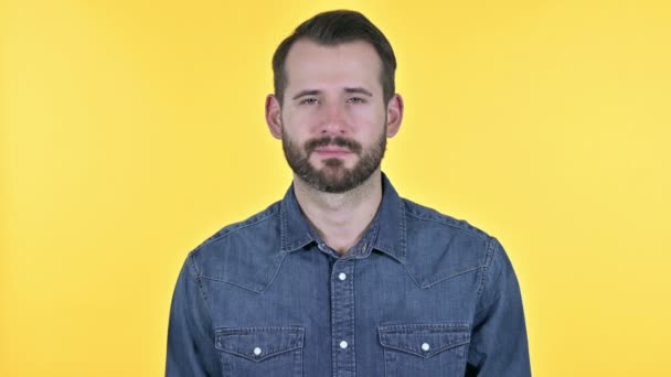 Cheerful Young Man Smiling at Camera, Yellow Background - Footage, Video