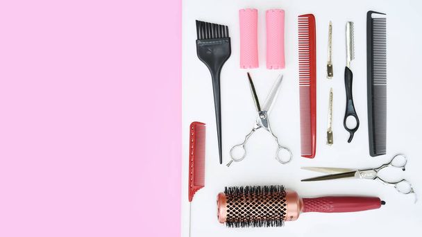Set of professional hairdresser tools on white and pink background - Photo, image