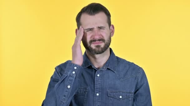Tired Beard Young Man having Headache, Yellow Background - Кадры, видео