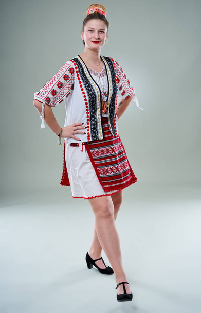 Young Romanian woman in popular costume, dancing on traditional music - Fotoğraf, Görsel