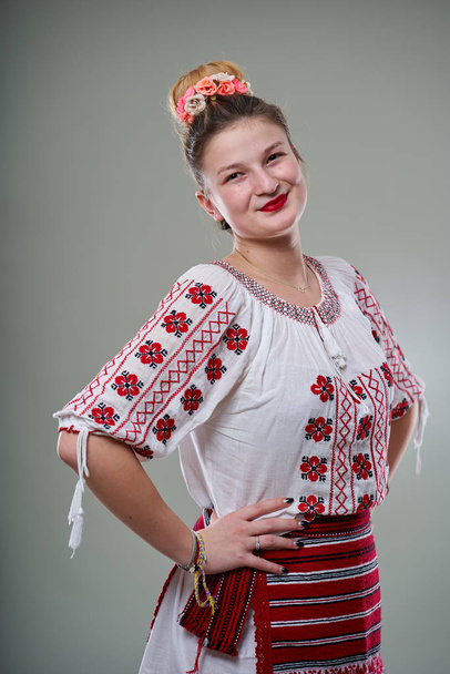 Young Romanian woman in traditional popular costume, studio shot - Photo, image