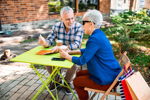 Beautiful old couple spending time together in outdoor cafe - Photo, image