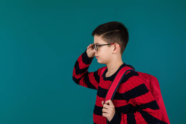 school boy wearing glasses with red backpack - Fotó, kép