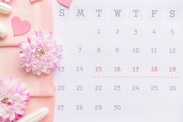Menstrual calendar with feminine products, top view - Foto, imagen