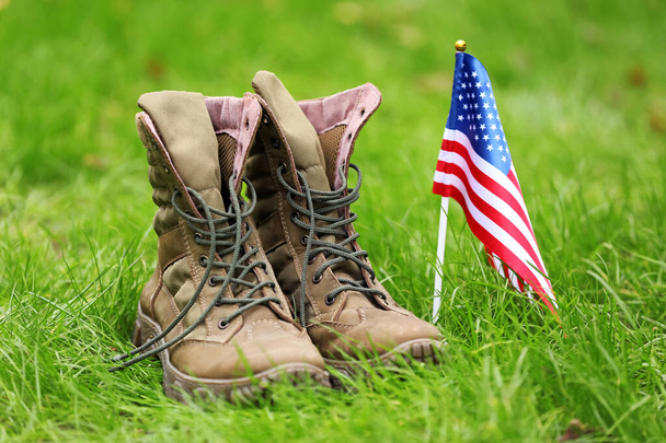 Military boots and USA flag outdoors. Memorial Day celebration - Fotoğraf, Görsel