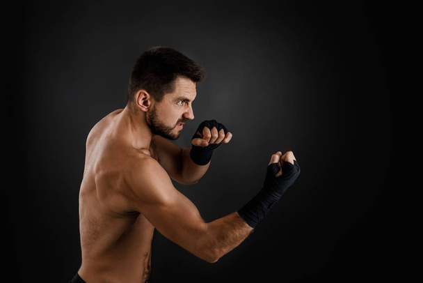 boxer throwing a fierce and powerful punch. - Фото, зображення