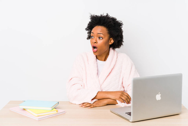 Middle aged african american woman working at home isolated being shocked because of something she has seen. - Fotografie, Obrázek