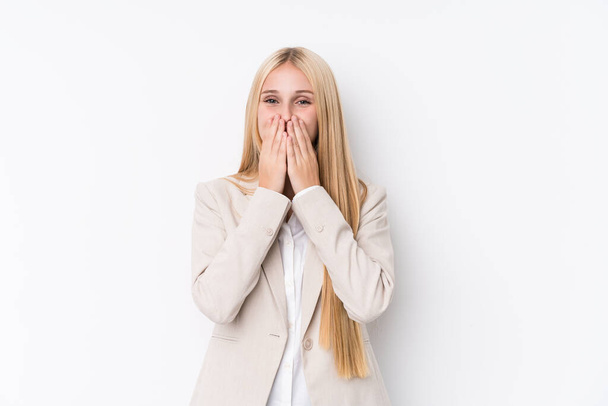 Young business blonde woman on white background laughing about something, covering mouth with hands. - Valokuva, kuva