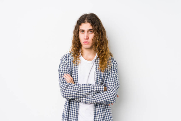 Young long hair man posing isolated unhappy looking in camera with sarcastic expression. - Fotó, kép