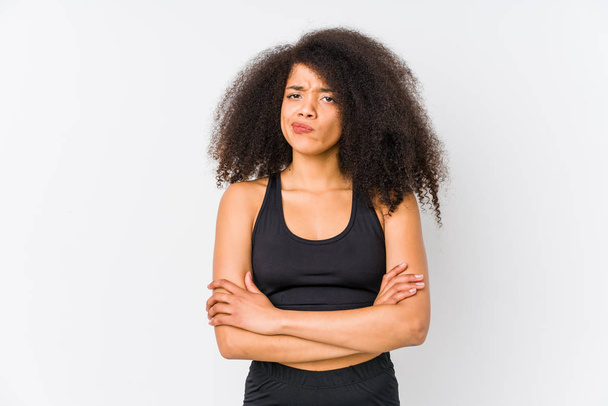 Young african american sporty woman frowning face in displeasure, keeps arms folded. - 写真・画像