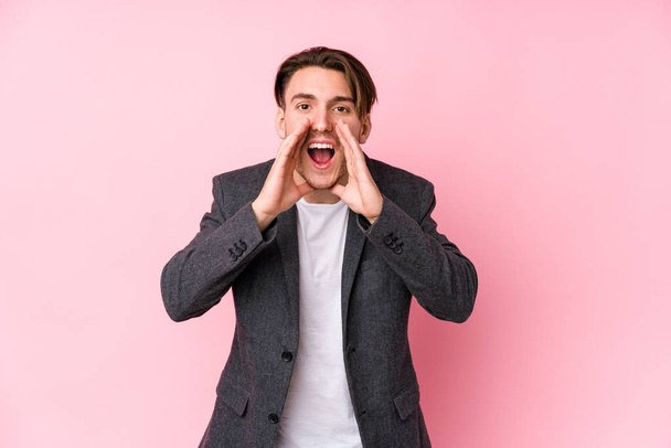 Young caucasian business man posing isolated shouting excited to front. - 写真・画像