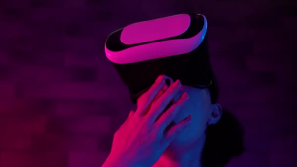Shocked female gamer in 3d headset feeling afraid, virtual reality effects, VR - Video