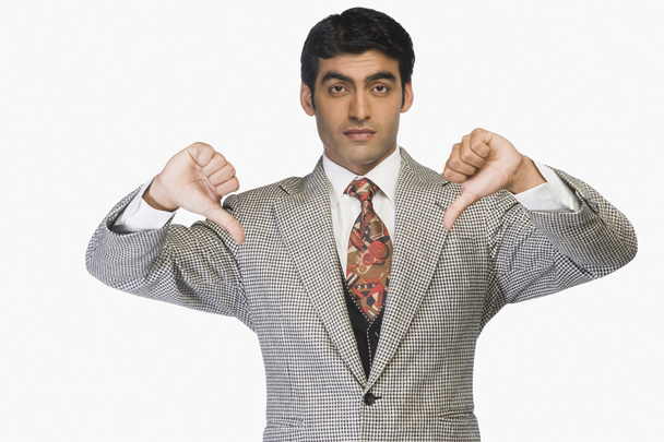 Businessman showing thumbs down - Foto, afbeelding