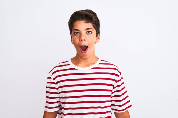 Handsome teenager boy standing over white isolated background afraid and shocked with surprise expression, fear and excited face. - Photo, Image