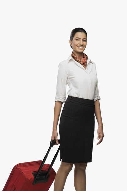 Air hostess carrying her luggage - Foto, afbeelding