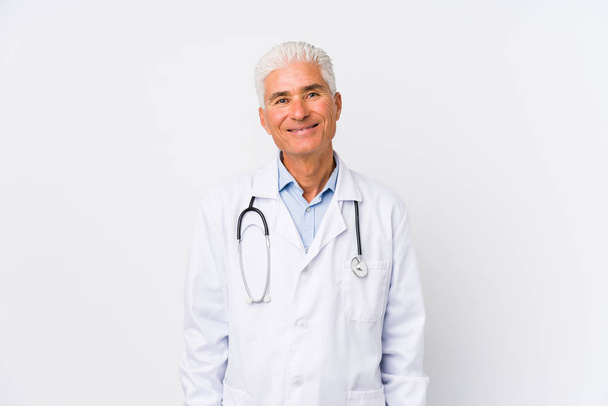 Mature caucasian doctor man happy, smiling and cheerful. - Photo, Image