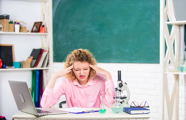 Stressful scientist. Girl tired stressful expression with laptop and microscope working investigation biology and chemistry. Pressure nervous tense. Teacher stressful occupation. Stressful educator - Foto, imagen
