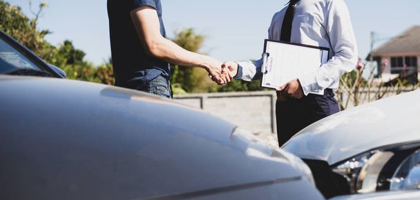 Customers shake hand with car insurance agents to enter into friendly terms and conditions, Car crash on the road concept. - Photo, Image