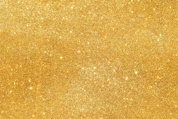 sparkles of golden glitter abstract background - Foto, afbeelding