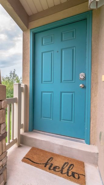 Vertical Blue green door of a home with doormat railing and stone pillar at the entrance - Photo, Image
