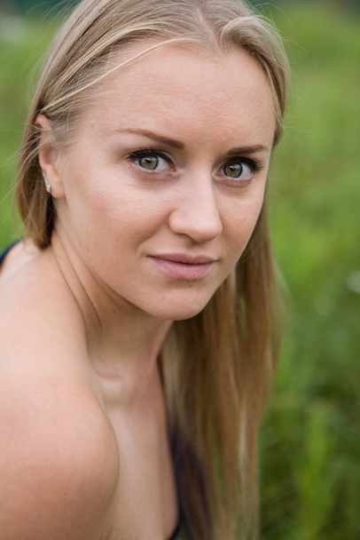 The face of a young natural blonde close-up. - Valokuva, kuva