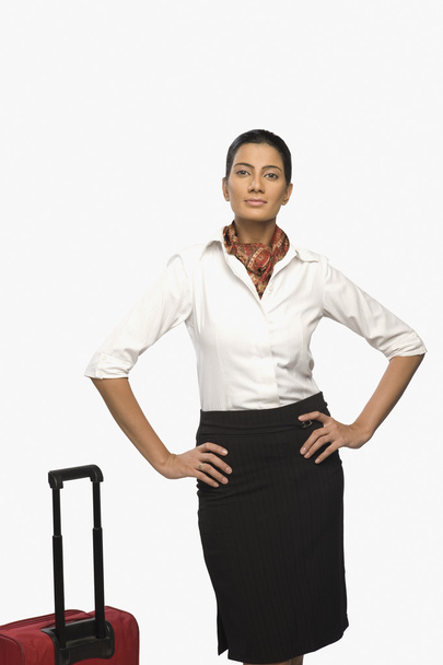 Air hostess with her luggage - Foto, imagen
