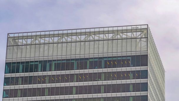 Pano Moderno edificio comercial exterior con altas ventanas de cristal contra el cielo nublado
 - Foto, Imagen