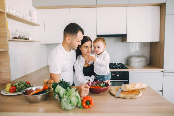 Family prepare the salad in a kitchen - Foto, Imagem