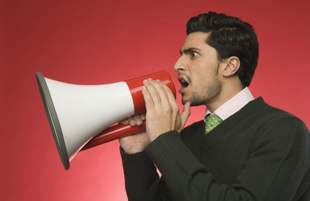 Businessman shouting into a megaphone - Foto, imagen