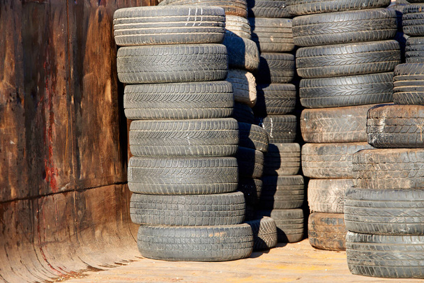 Stacks of old used car tires in recycle centreUsed old black car tire rubber - Photo, Image