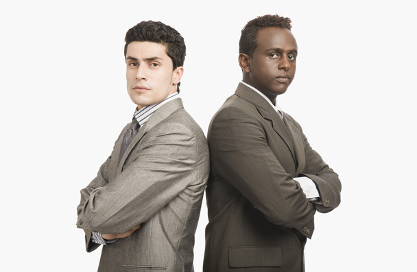 Two businessmen standing back to back - Фото, зображення