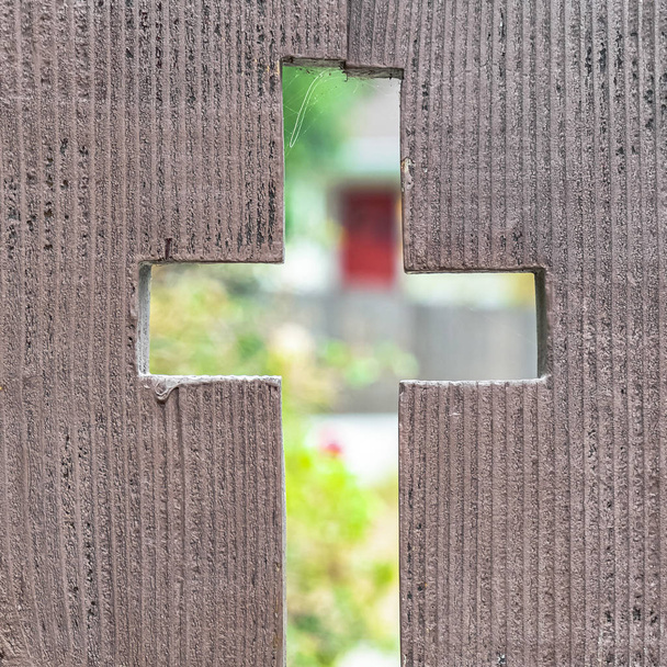 Square frame Cross shaped opening in a rustic wooden fence - Photo, Image