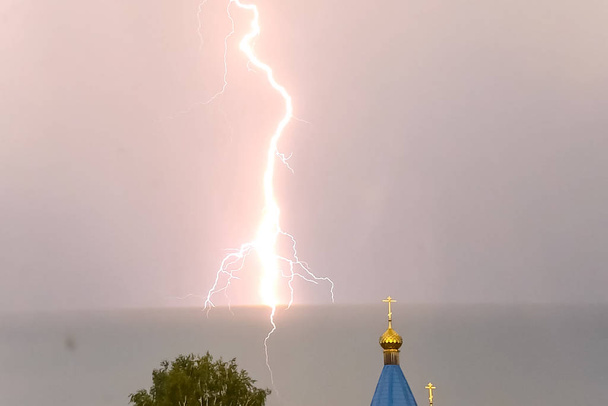 Lightning during a thunderstorm in the sky above the dome and cr - Photo, Image