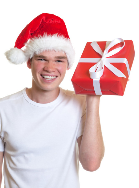Laughing guy with christmas hat and gift - Valokuva, kuva