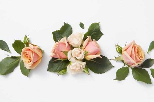 Romantic composition from beautiful roses flowers on a light grey background with copy space. Flat lay. Greeting card for Valentine's Day. - 写真・画像