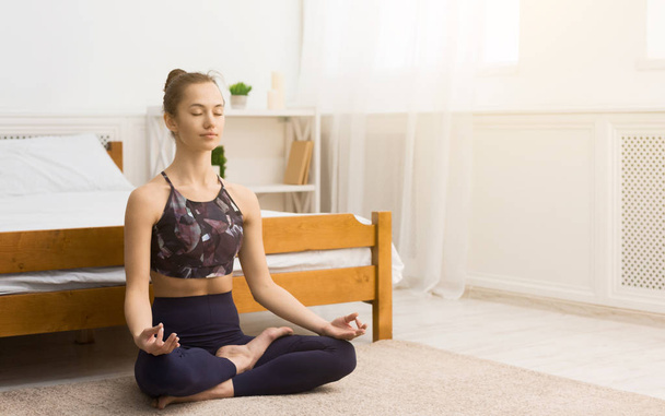 Morning routine. Calm woman enjoying yoga training - Фото, изображение