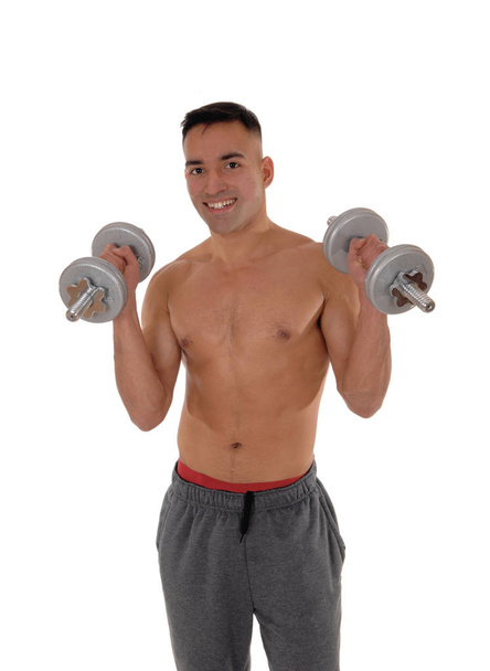 Close-up of a man with two dumbbells working out - Photo, Image