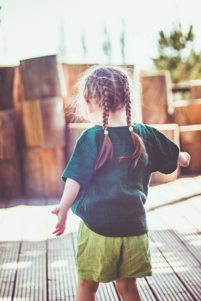 Ritratto di felice simpatica bambina emotiva in stile rurale cappello marrone e vestiti di mussola in una giornata estiva
. - Foto, immagini