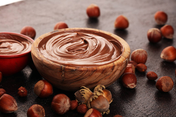 Homemade hazelnut spread in wooden bowl. Hazelnut Nougat cream w - Photo, Image